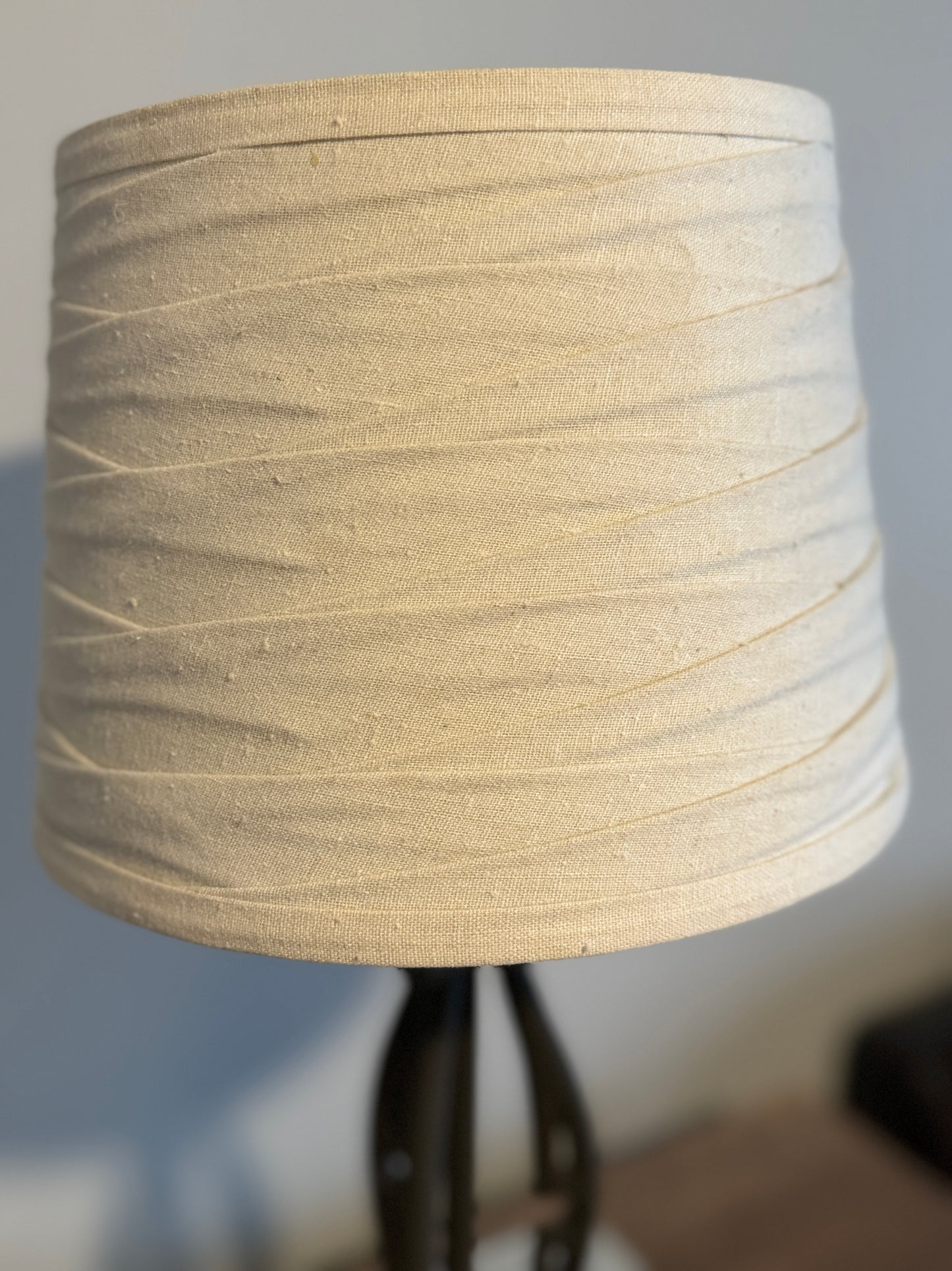 Wrought iron lamp with gathered linen shade